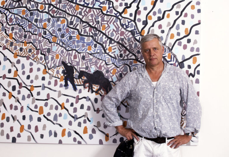 Hans Heiner Buhr standing in front of his painting Atsunta Pass at Vernissage Gallery Tbilisi, June 2026