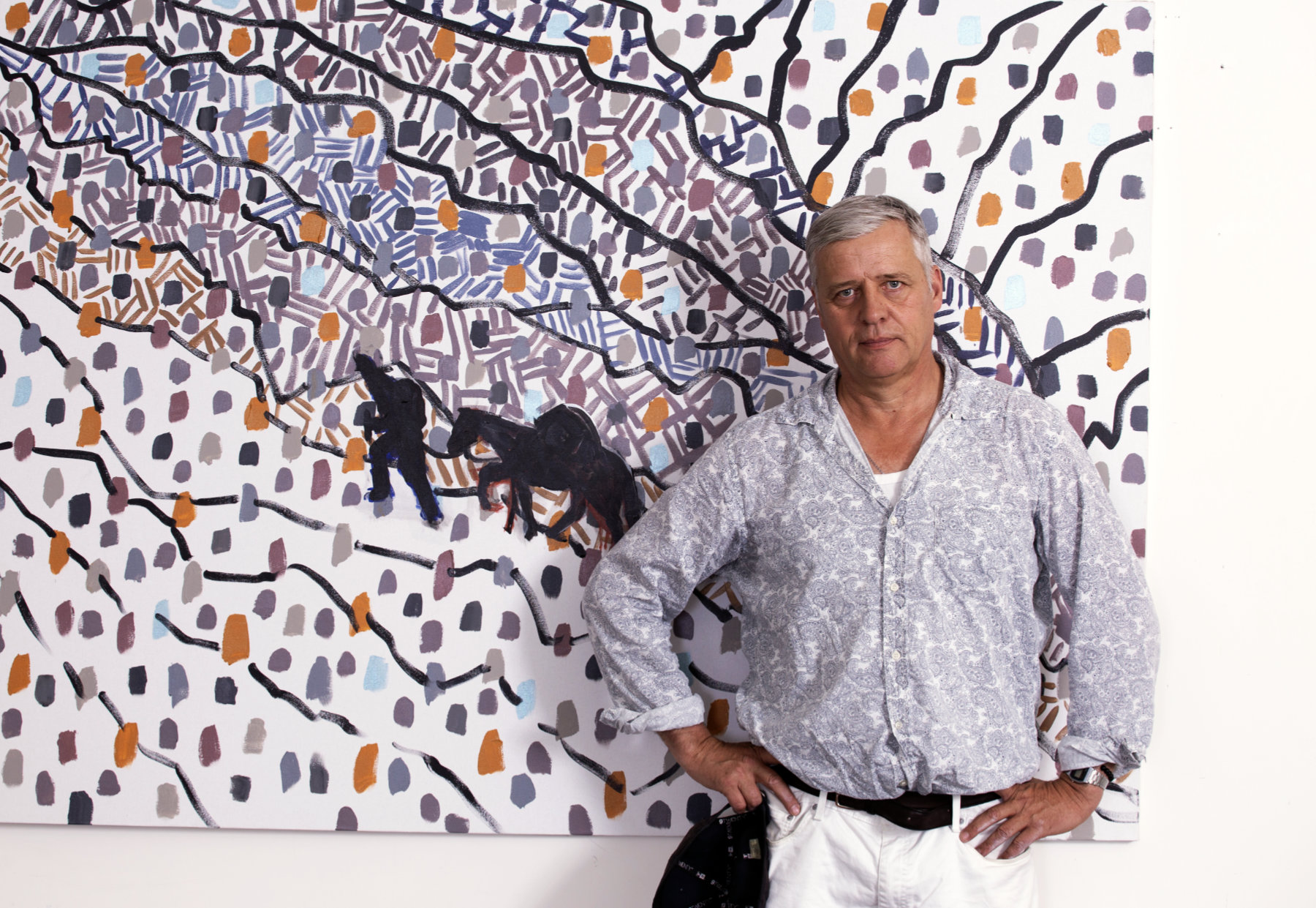 Hans Heiner Buhr standing in front of his painting Atsunta Pass at Vernissage Gallery Tbilisi, June 2026